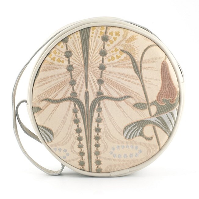 Round handbag made of elegant art nouveau fabric, combined with cream-coloured leather.