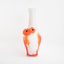 White glass vase with orange red tomatoes