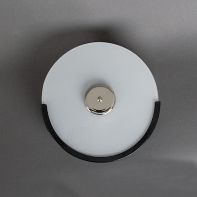 Staircase wall lamp with black finish and opal white, round shaped glass.