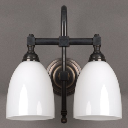 Bathroom wall lamp with bronze armature and opal white glass shades
